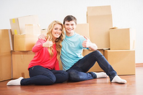 Local movers loading boxes and furniture into a van