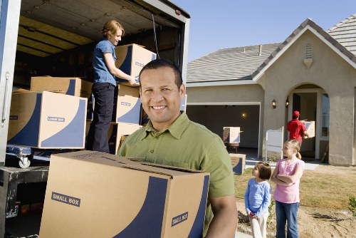 Loading furniture into a removal truck in a Freezywater residential street