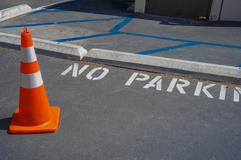 A rectangular white parking restriction sign mounted on a metal pole against a blue sky with some clouds. The sign displays a black letter 'P' crossed out with a red circle and slash, indicating no parking, and includes a black arrow pointing to the right at the bottom. In the context of house removals and relocation services, such signage is relevant for locating designated parking areas for delivery and moving vehicles. Man with Van Freezywater, a professional removals company, would consider parking restrictions like this when planning home relocation and furniture transport. The sign's placement and visibility are crucial for ensuring smooth loading processes, such as loading furniture, boxes, or appliances into a moving van. The image highlights the importance of understanding parking regulations to facilitate efficient packing and transport during house moves, particularly in urban or restricted parking zones.